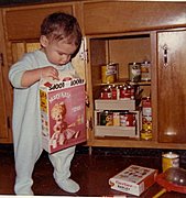 Marc as a Toddler Exploring Kitchen Cabinets