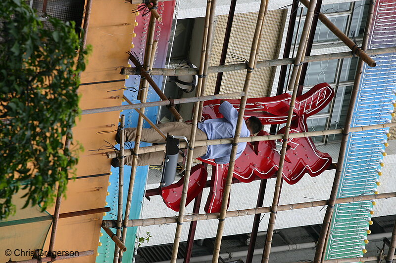 Photo of Worker Repairing Neon Sign(3225)