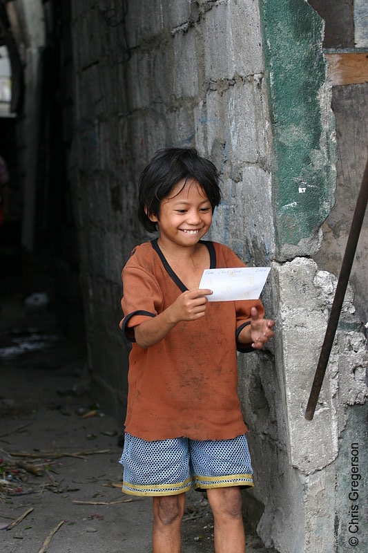 Photo of Child Smiling, Holding a Photograph(4315)