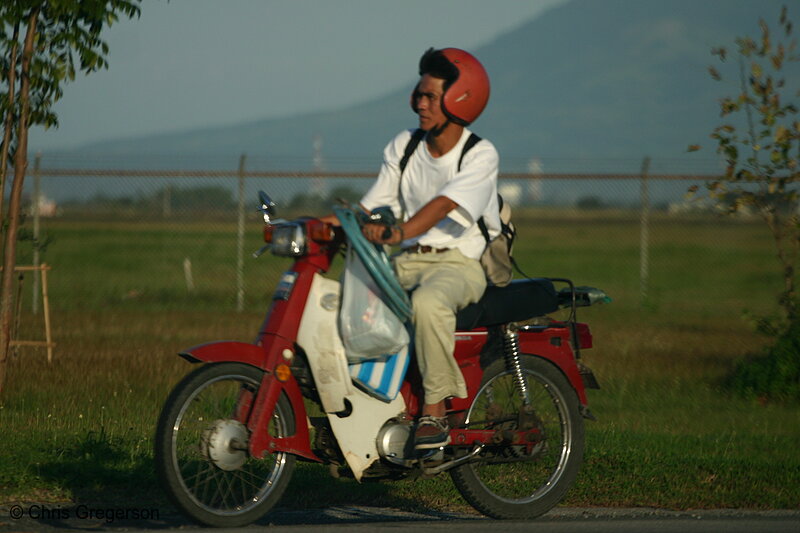 Photo of Man Riding a Parked Motorcycle with Red Helmet(5294)