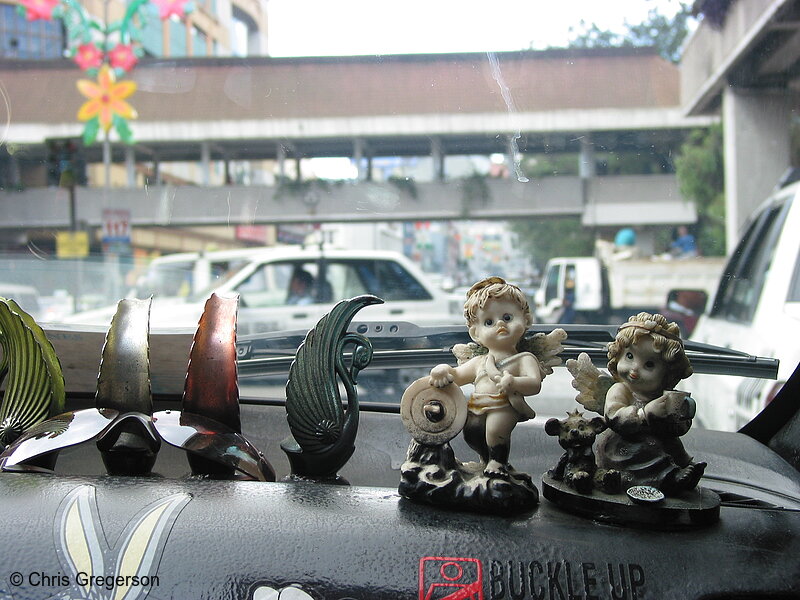 Photo of Figurines in the Dashboard of a Taxicab(5783)