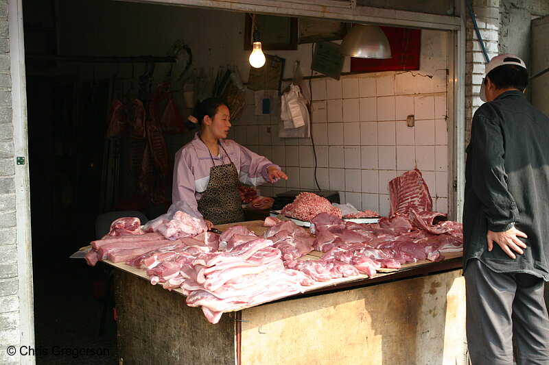 Photo of Woman Butcher Selling Meat to a Customer in Beijing(6051)