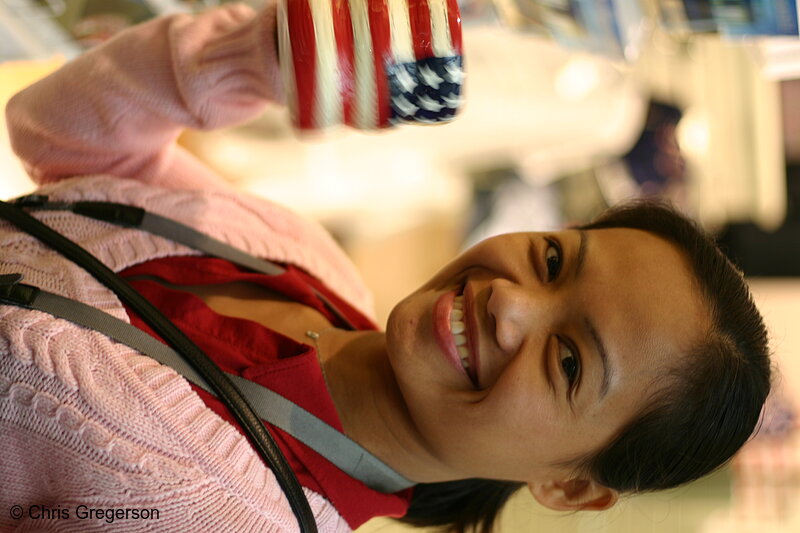 Photo of Woman Smiling with an American Flag Coffee Cup at a gift shop in Washington D.C.(6176)