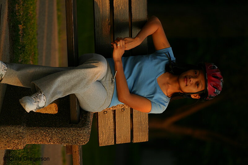 Photo of Young Woman with Bike Helmet Sitting on Bench(7622)