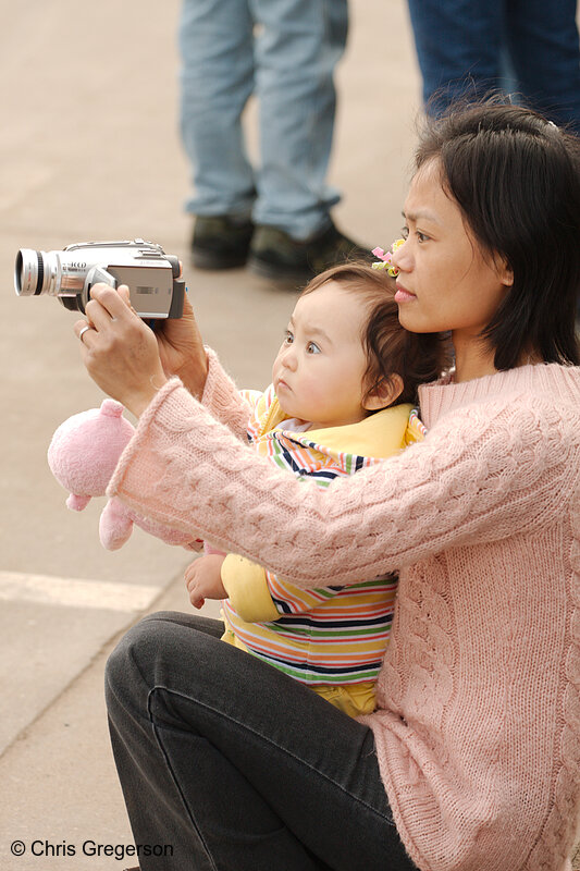 Photo of Mother and Child Using Camcorder at a Parade(7644)