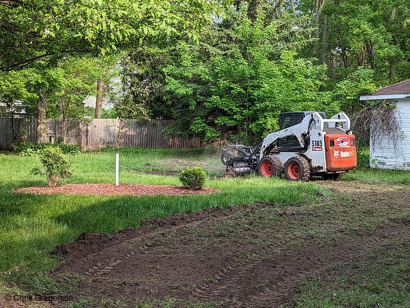 Photo of Bobcat with Harley rake in the backyard (8355)